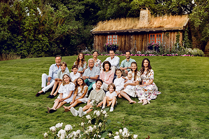 The Royal Couple sit together with their children and grandchildren in a meadow.
